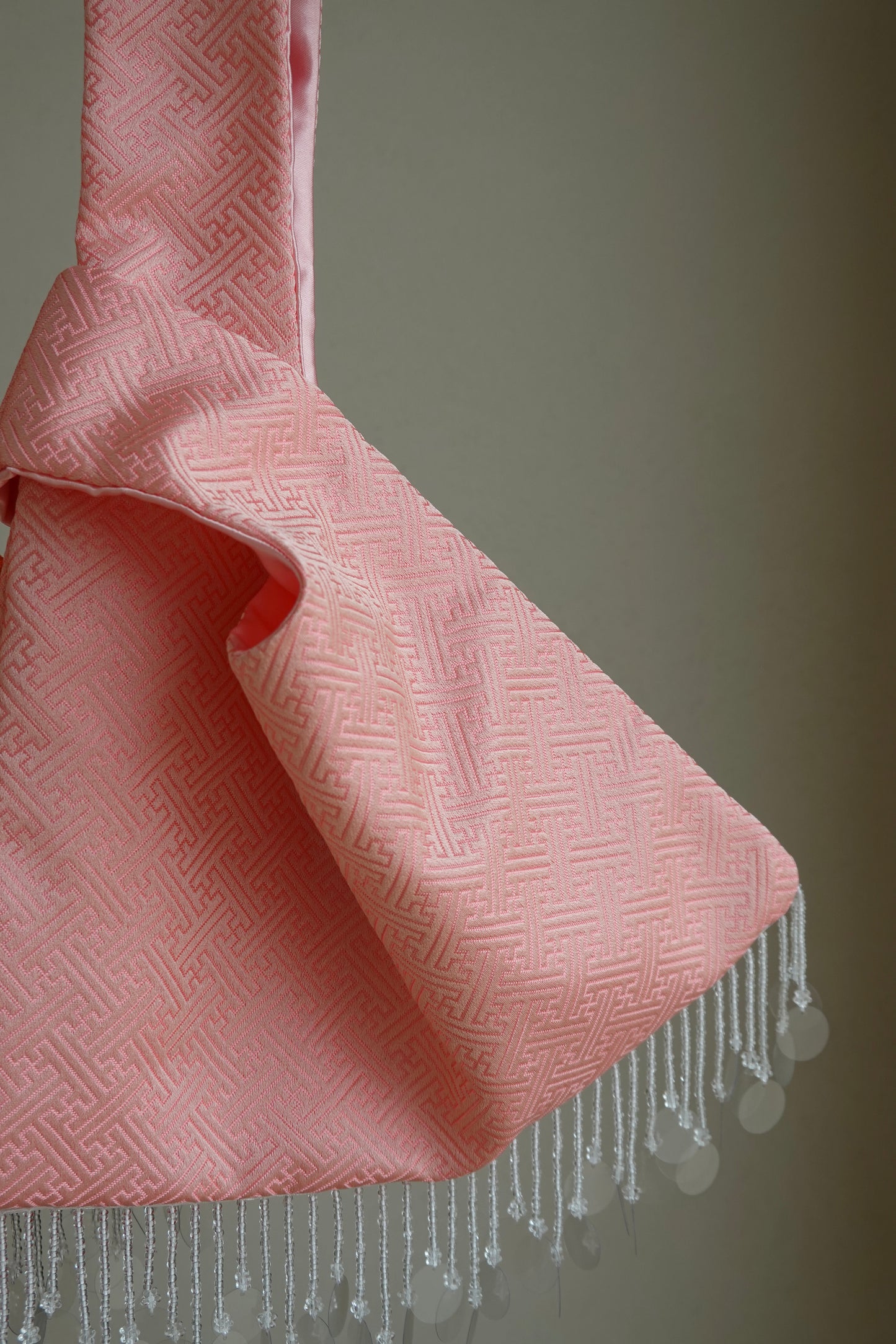Pink textured fabric with cascading beads