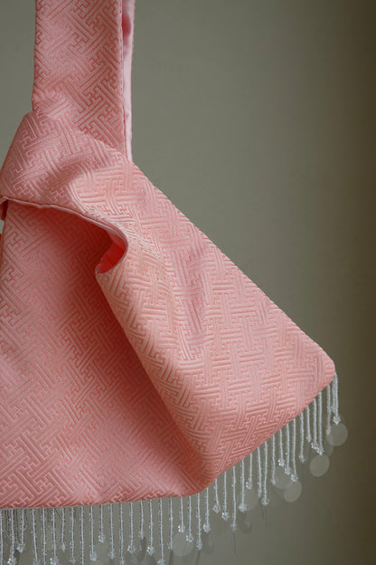Pink textured fabric with cascading beads