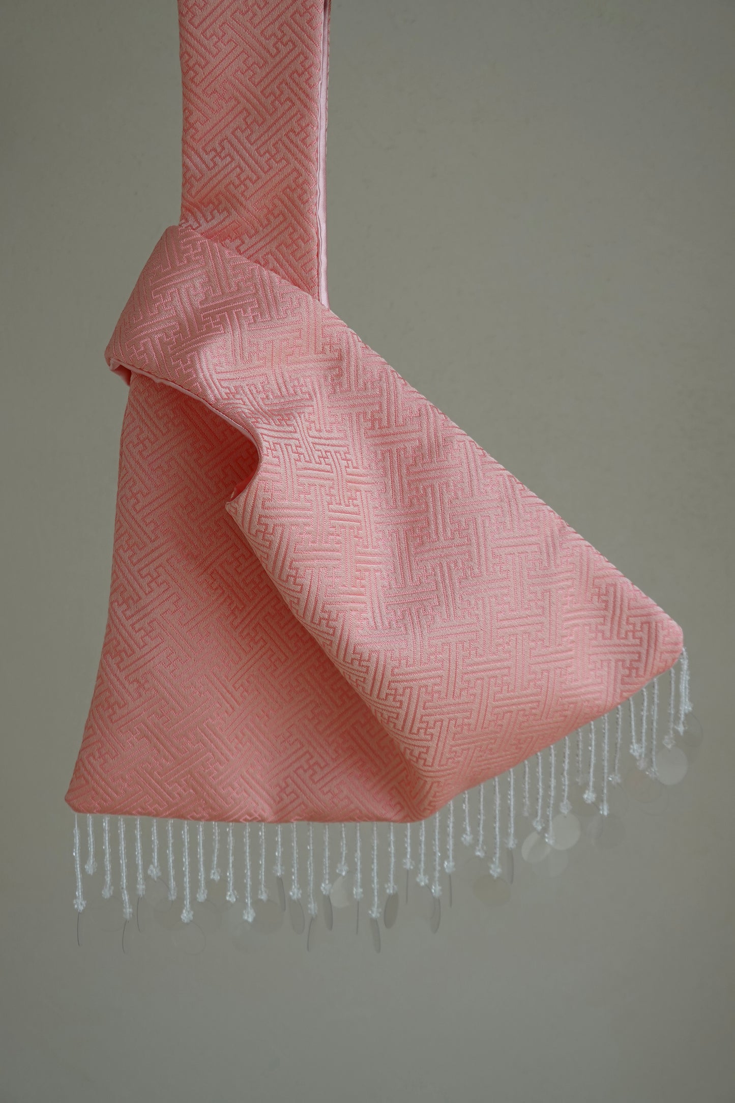 Pink textured bag with white fringe 