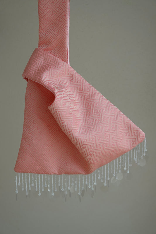 Pink textured bag with white fringe 